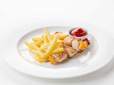 Chicken skewers with French fries and tomato soup